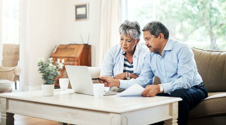 A couple looking at a laptop together in thier living room