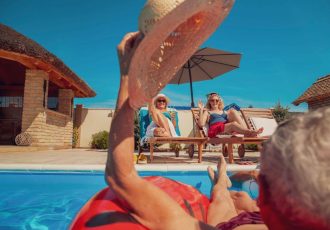 seniors in pool at senior living apartments with pool